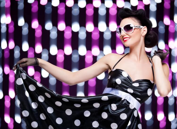 a woman wearing a black and white polka dot dress