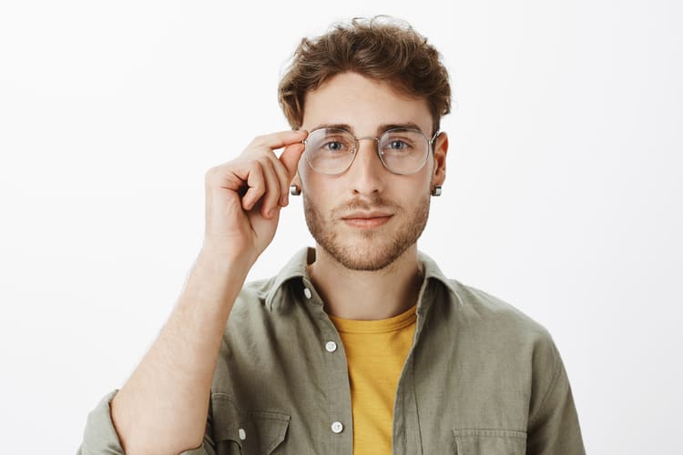 Handsome man with eyeglasses posing in the studio