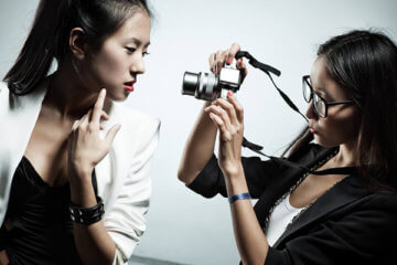 girl taking picture of another girl