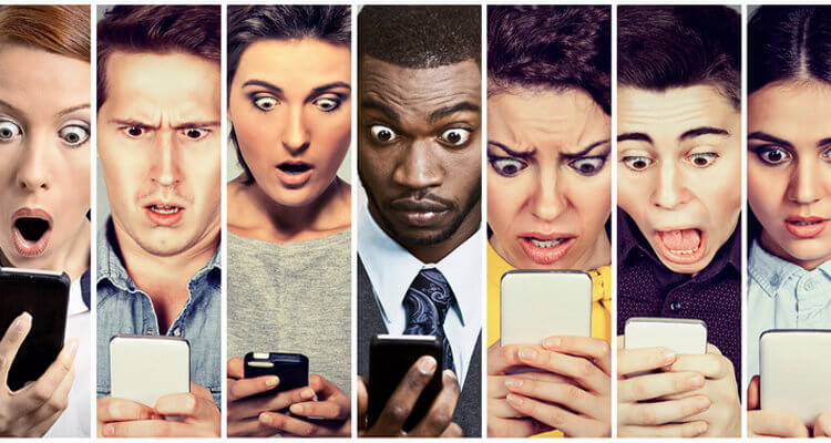 men and women looking shocked at mobile phone