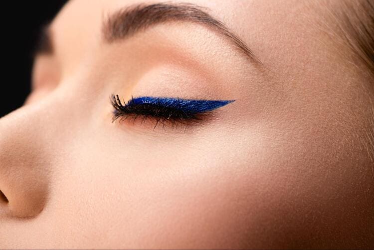 Woman With Closed Eyes Wearing Blue Eyeliner